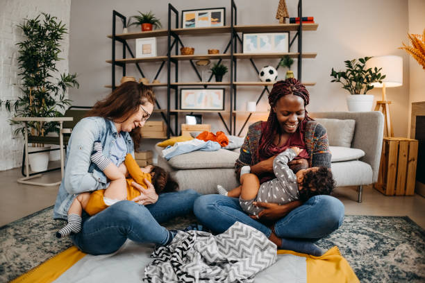 Friends at home with babies. stock photo