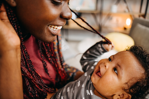 Shot of a mother spending time with her newborn baby