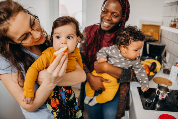 Mothers with babies in the kitchen at home