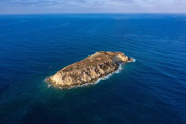 A top view of the inhabited Geronisos island surrounded by a blue seascape in Cyprus