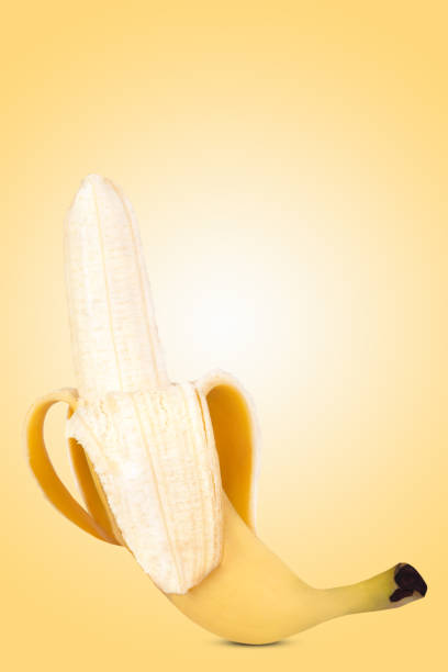 istock One ripe banana on yellow background. 1452359938