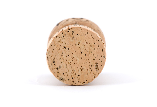 Cork close up on white surface with shadow