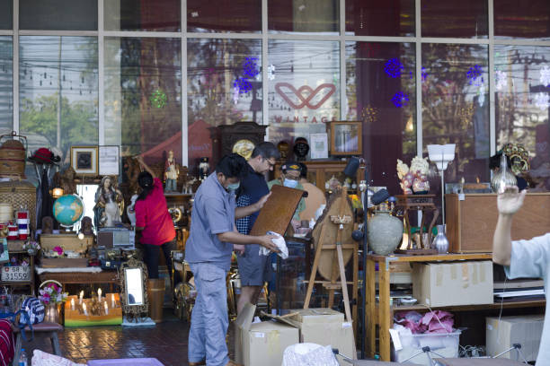 Beijing, China - December 5, 2013 - Vendor sells Chinese antiques to customers in the Baoguosi antique market.