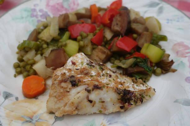 istock Fried cod fillet seasoned with dried seaweed served with pan-fried mixed vegetables cooked in a wok 1452362310