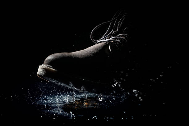 Water splashes under the boot stock photo