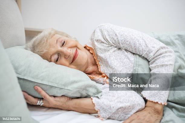 Senior Woman Sleeping In Bed Stock Photo - Download Image Now - Sleeping, Senior Adult, Bed - Furniture