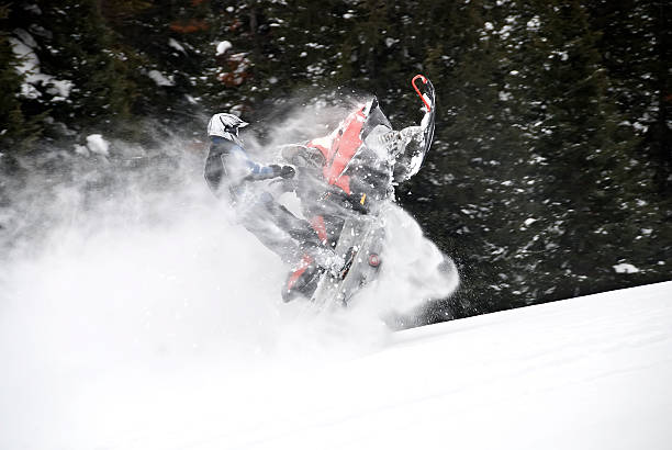 istock Snowmobilier jumping on a mountain 145236619
