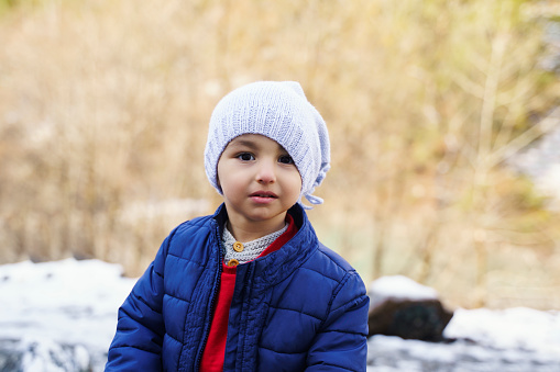 Cute little boy portrait wearing warm clothes in winter