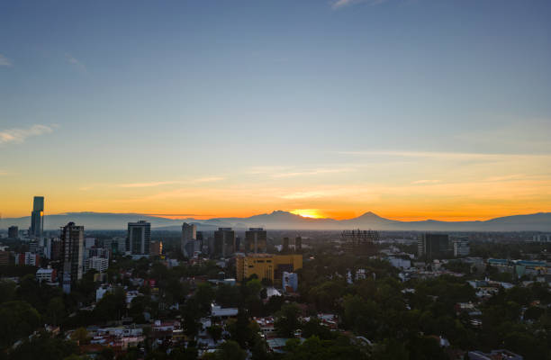 Mexico City, San Angel district at dawn with volcanoes in the background