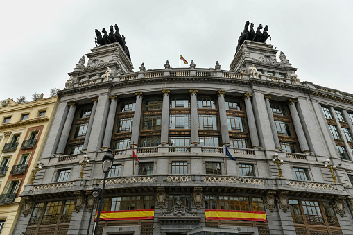 Madrid, Spain - Nov 20, 2021: The old Bilbao Vizcaya Bank building (today BBVA) with quadrigas on the top.