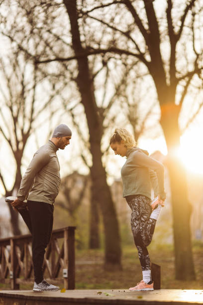 istock Man and woman exercising in nature 1452370216