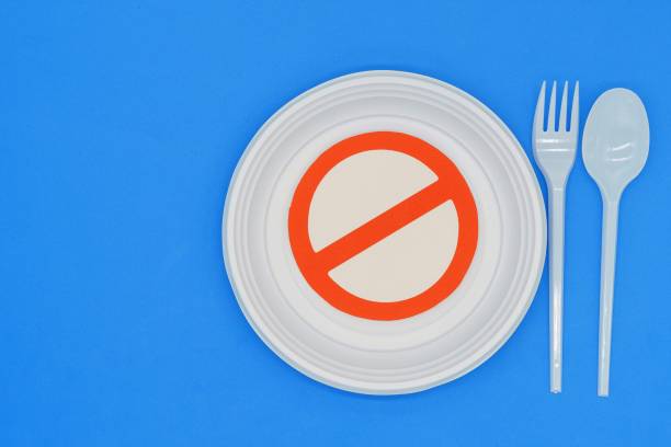 istock Prohibited symbol on plastic plates and cutlery. Ban on single-use plastics. Environmental concept. Do not damage the planet 1452371097