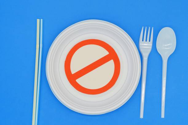 istock Prohibited symbol on plastic plates and cutlery. Ban on single-use plastics. Environmental concept. Do not damage the planet 1452371643