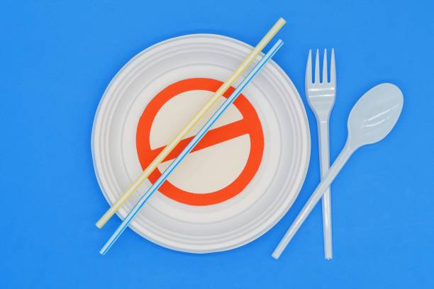 istock Prohibited symbol on plastic plates and cutlery. Ban on single-use plastics. Environmental concept. Do not damage the planet 1452371645