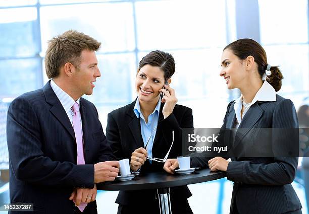 Businesspeople Having Coffee Break Stock Photo - Download Image Now - Mid Adult Men, Office, Three People