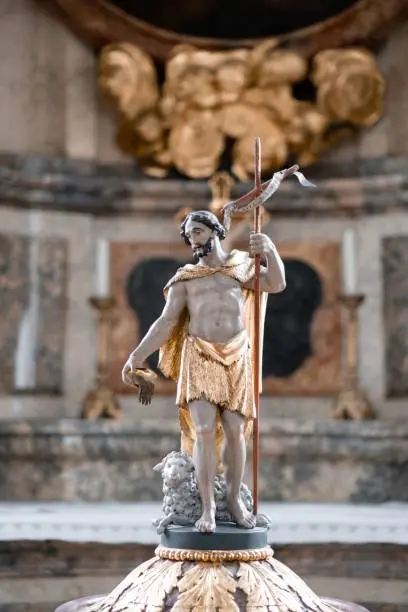 A vertical shot of a religious statue inside the St. Lorenz Basilica in Kempten, Bavaria, Germany