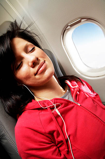 istock young woman is on passanger seat at airplane 145237392