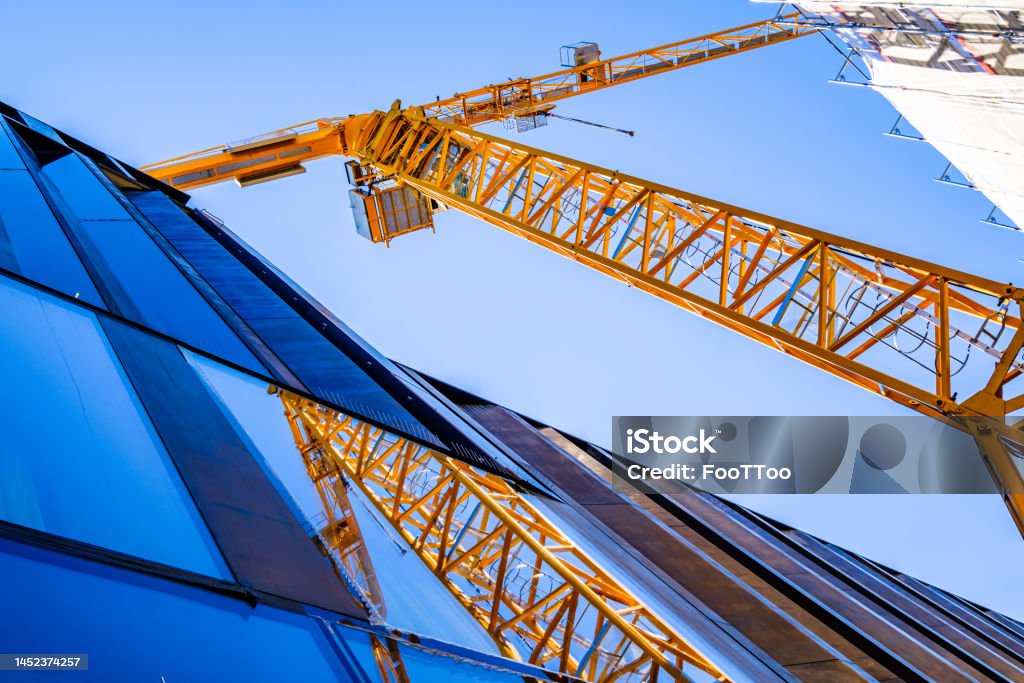 modern crane at a construction site modern crane at a construction site - photo Construction Site Stock Photo