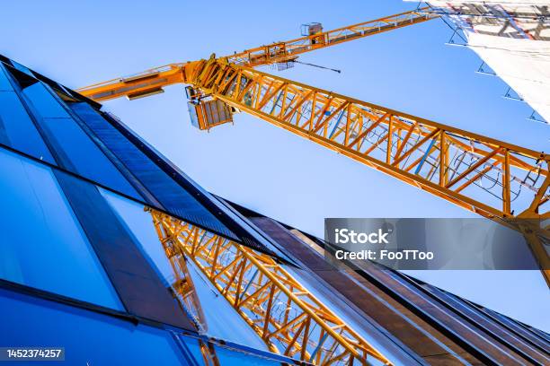 Modern Crane At A Construction Site Stock Photo - Download Image Now - Construction Site, Construction Industry, Crane - Machinery