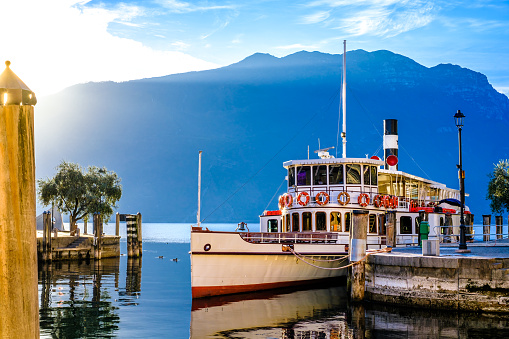 Holidays in Italy - Scenic view of the marina with a ferry in Varenna on Lake Como