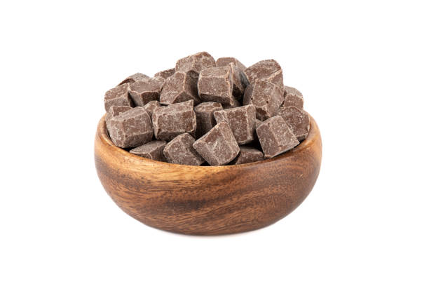 istock Diamond shaped chocolate in a wooden bowl over white background. 1452375059