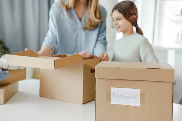 istock Mother and daughter preparing donation boxes at home 1452375839