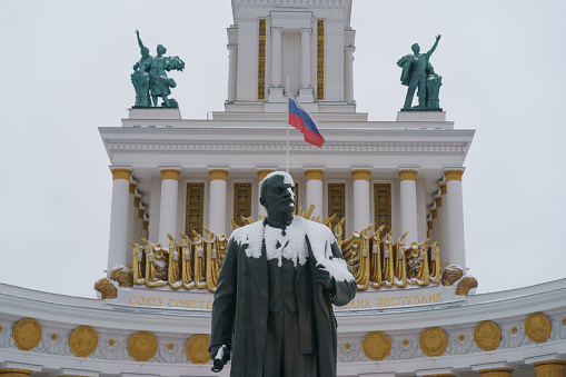 Moscow, Russia - December 15, 2022: Vladimir Lenin statue in the Exhibition of Achievements of National Economy (VDNKh) in Moscow. Photography in snowy winter day. The statue is covered by snow