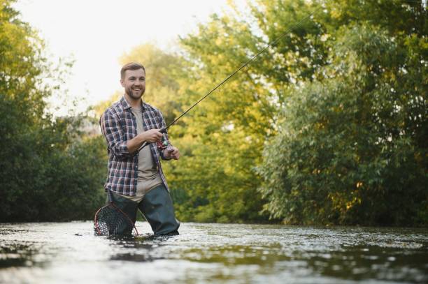 istock Trout fishing on mountain river 1452378641