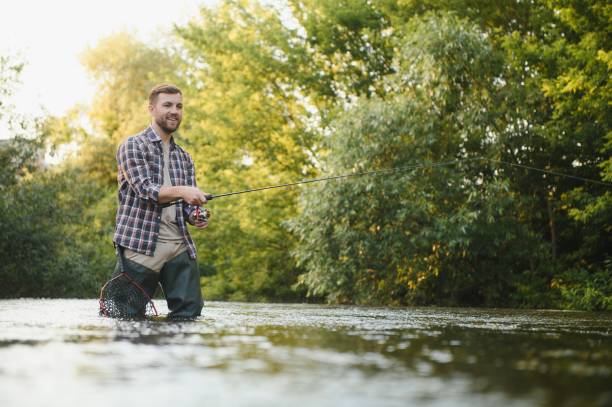 istock Fisherman catches a trout on the river in summer 1452378647