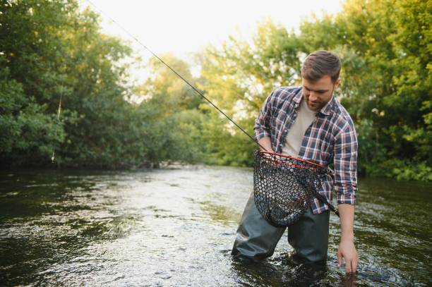 istock Trout fishing on mountain river 1452378712