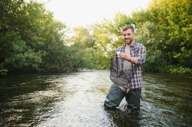 istock Young man flyfishing at sunrise 1452378716