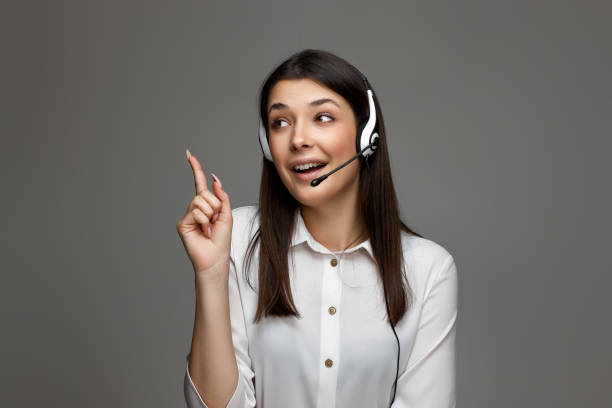 istock friendly smiling woman with headset is consulting clients online. 1452378951