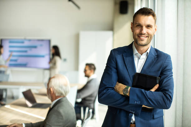 istock Confident young man businessman working inside modern office on a digital tablet 1452382025