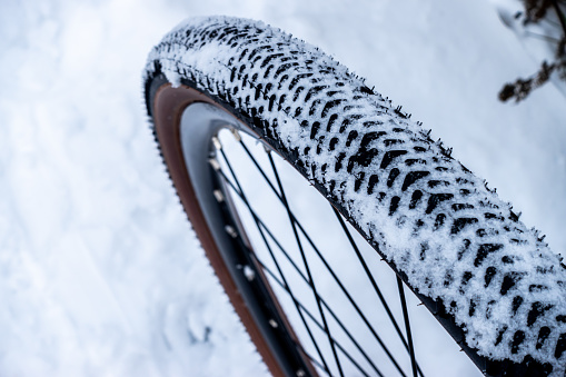 A winter ride on a gravel bike along heavily snow-covered forest paths.