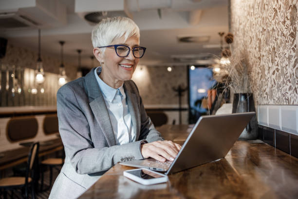 istock Senior woman working online in a cafe 1452382280