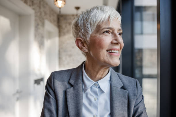 istock Cheerful woman looking through the window 1452382520