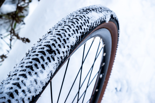 A winter ride on a gravel bike along heavily snow-covered forest paths.