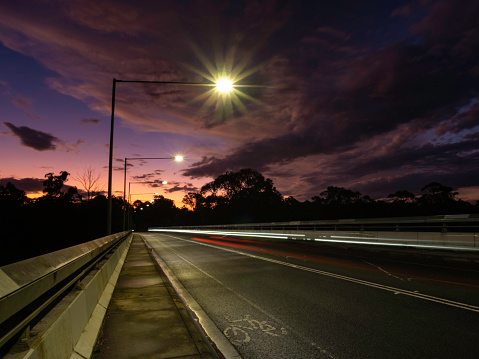 Sunset and light trails on a suburban street