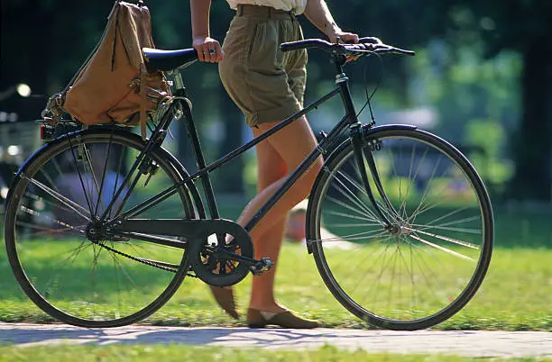 Photo of elegant woman and her bicycle
