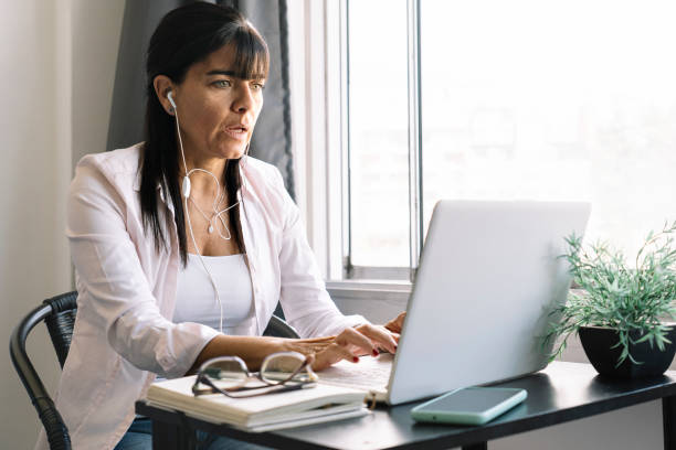 istock Young woman working at home using a laptop. 1452397948