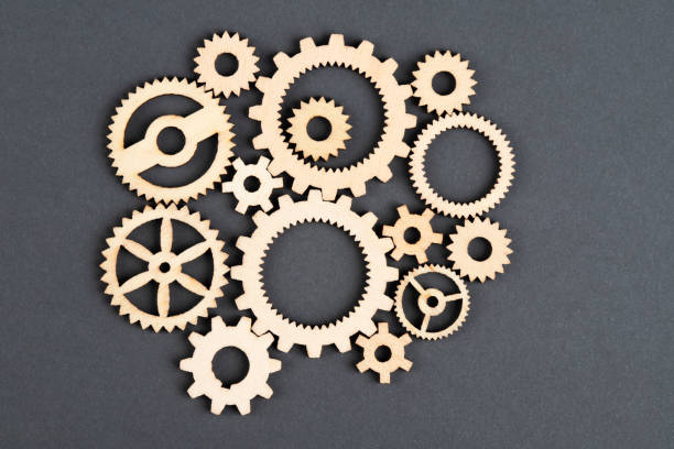 istock Wooden gears on black background 1452398462