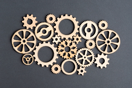 Wooden gears on black background