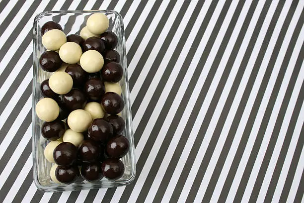 Vanilla and Dark Chocolate balls on a striped background