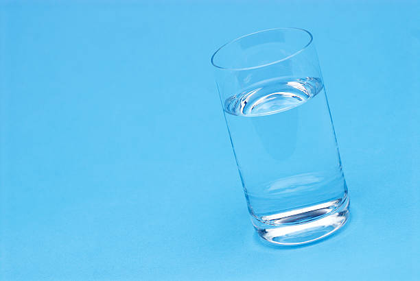 istock Glass of water isolated on blue 145240093