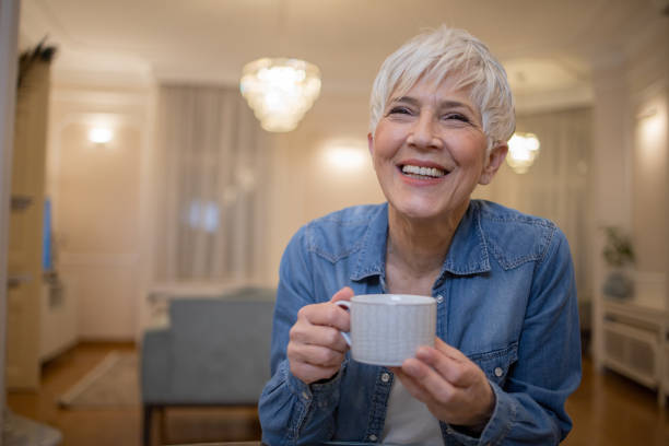 istock Woman having coffee and relaxing at home 1452403373