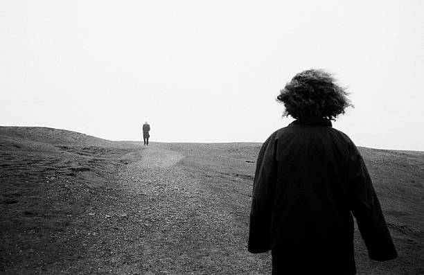istock A person walks far ahead of another on an empty path 145240443