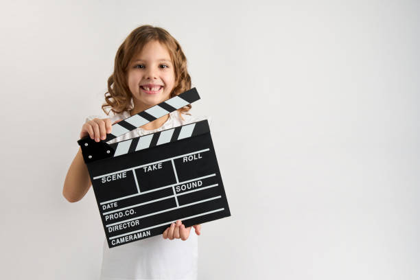 istock Little girl holding filmmaking clapperboard 1452404939