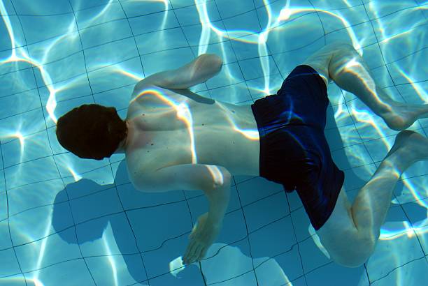 Man swimming in a pool stock photo