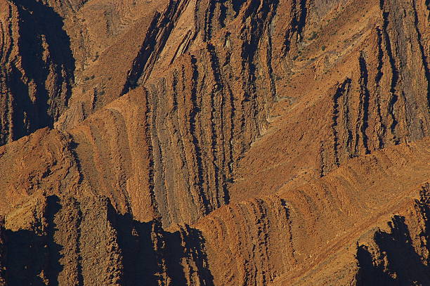 Folded sandstone cliff in Morocco A folded sandstone cliff in Morocco syncline stock pictures, royalty-free photos & images
