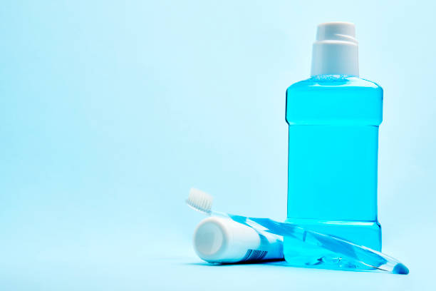 istock A toothbrush with toothpaste and mouthwash on blue background 1452407343
